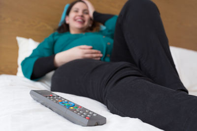 Woman lying on sofa at home