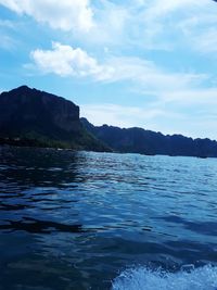 Scenic view of sea and mountains against sky