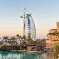 View of swimming pool in city against clear sky