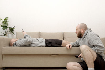 Men sitting on sofa