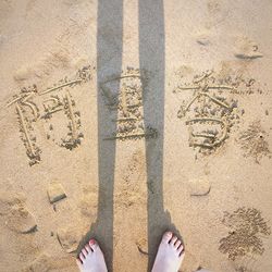 High angle view of woman standing on beach