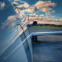 Airplane on runway against sky