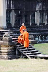 People sitting on staircase outside building