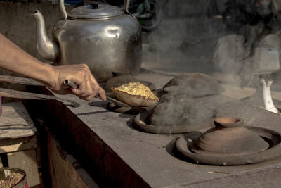 Man preparing food at market stall