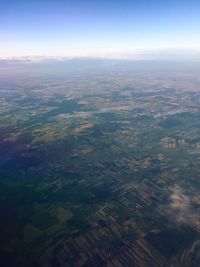 Aerial view of agricultural field against sky