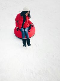 People sitting on snow covered landscape