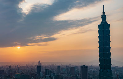 View of buildings against cloudy sky during sunset