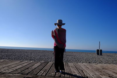 Full length of woman standing against clear sky