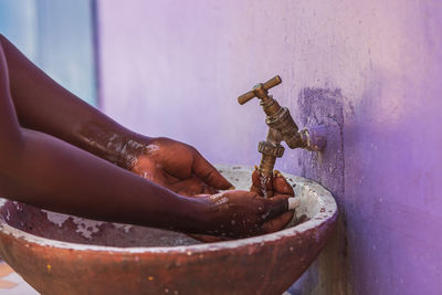 African woman washes her hands outdoors in a small village keta ghana west africa