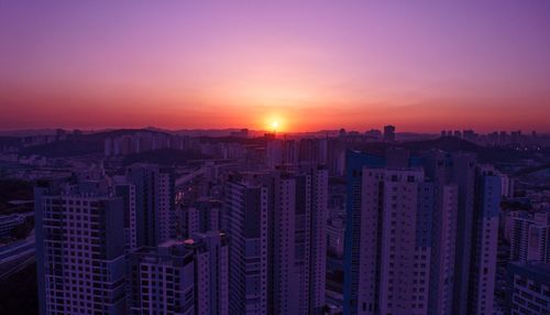 High angle view of buildings against sky during sunset