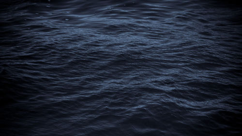 Dark sea water surface selenium tone background, ruffle waves