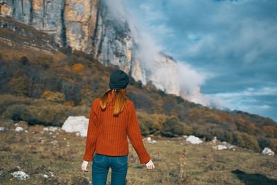 Full length of man standing on mountain against sky