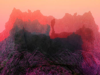 Scenic view of rock against sky during sunset