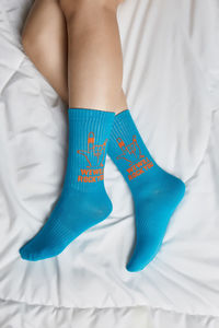 Low section of woman lying on bed