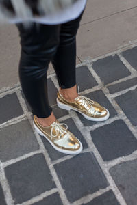 Low section of man standing on footpath