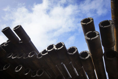 Stack of pipes in industry against sky