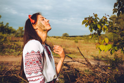 Photo of a smiling young woman in ethnic ukrainian shirt