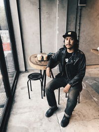 Portrait of young man sitting on the chair