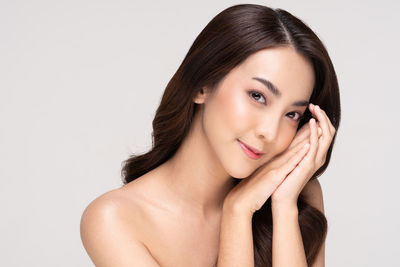 Portrait of a beautiful young woman over white background