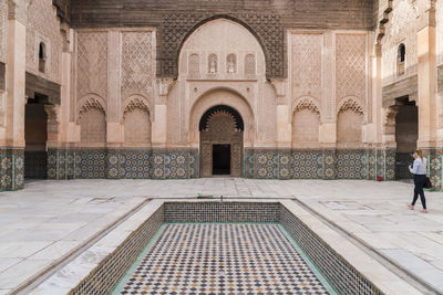 Madrasa ben youssef islamic school with tourist taking photo