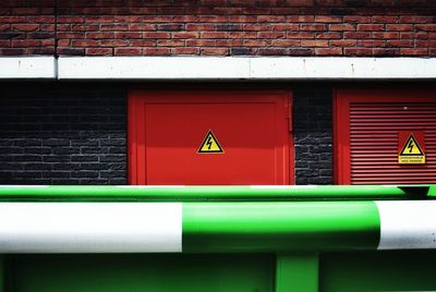 Close-up of arrow sign on wall of building