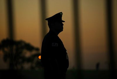 Silhouette of person standing against black background