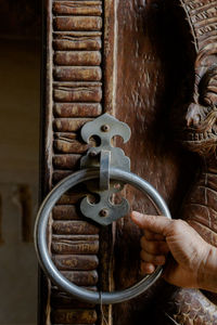Close-up of hand holding door handle