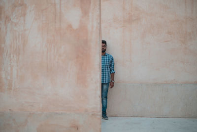 Man standing against wall