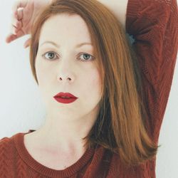 Close-up portrait of beautiful woman with red lipstick