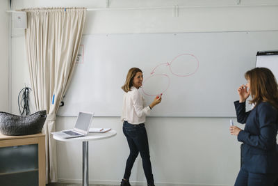 Woman standing with text on table