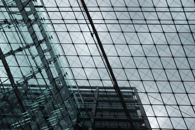 Double exposure of modern building against sky