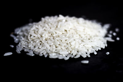 Close-up of raw rice against black background