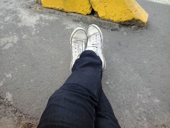 Low section of man standing on road