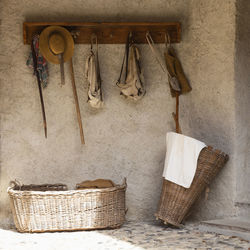 A retro style outdoor wardrobe with walking sticks, backpacks, baskets and travel equipment.