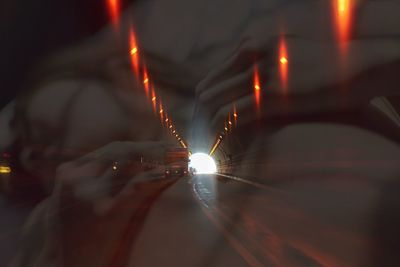 Close-up of hand on illuminated road
