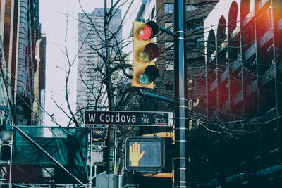 Low angle view of road sign against buildings in city