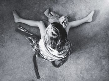 Directly above shot of girl playing with teddy bear on floor