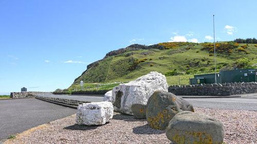 Scenic view of rocks against blue sky