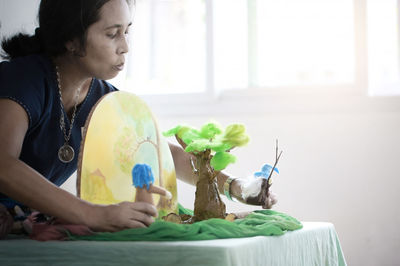 Woman sitting on table at home