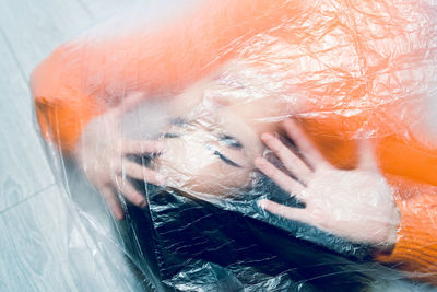 High angle view of woman seen through glass