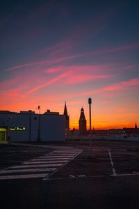 Silhouette buildings against sky during sunset in city