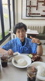 Portrait of a great mother with food on table