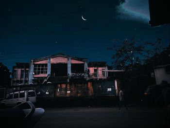 Illuminated buildings against sky at night