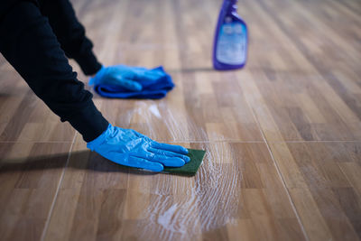 Low section of person relaxing on floor at home