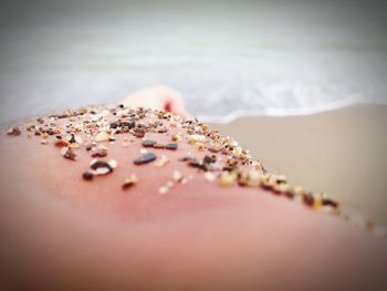 Close-up of water on sand at beach