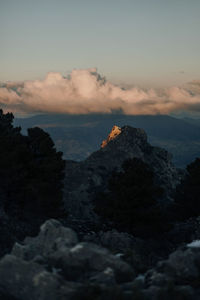 Scenic view of sea and mountains against sky at sunset