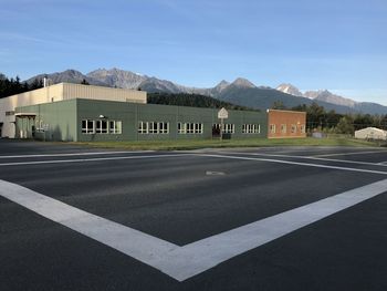 Road by building against sky