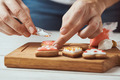 Midsection of person preparing food on cutting board