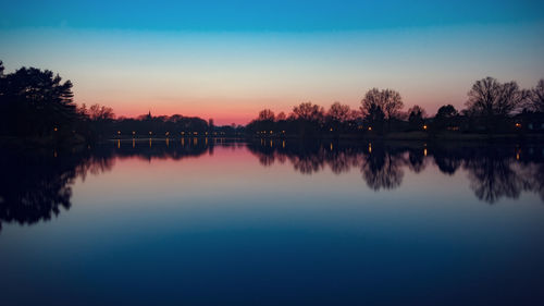 Scenic view of calm lake at sunset