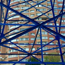 Low angle view of modern building against blue sky